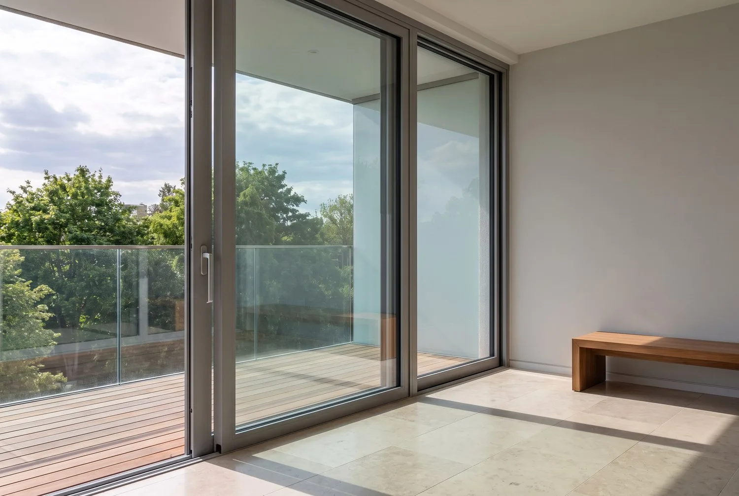 Full-height aluminium sliding unit opening to a balcony