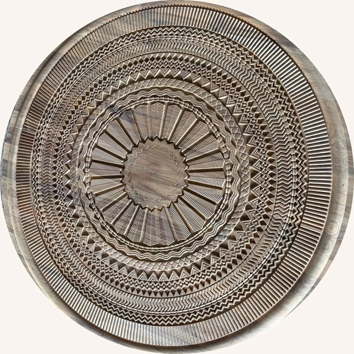 Intricately carved circular teak medallion