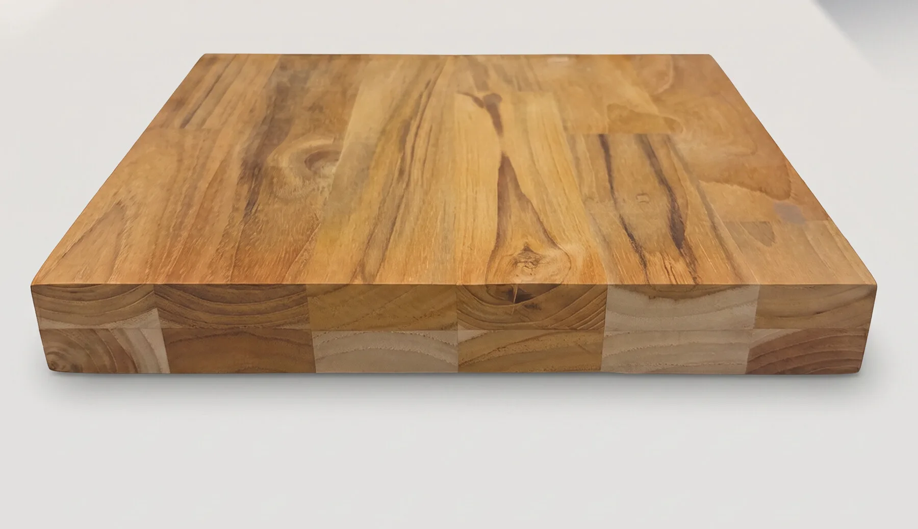 Thick teak finger-joint board showing the jointed edge and full thickness