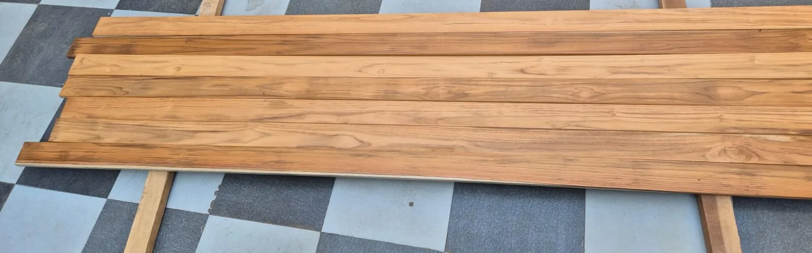 Planed teak planks in long lengths